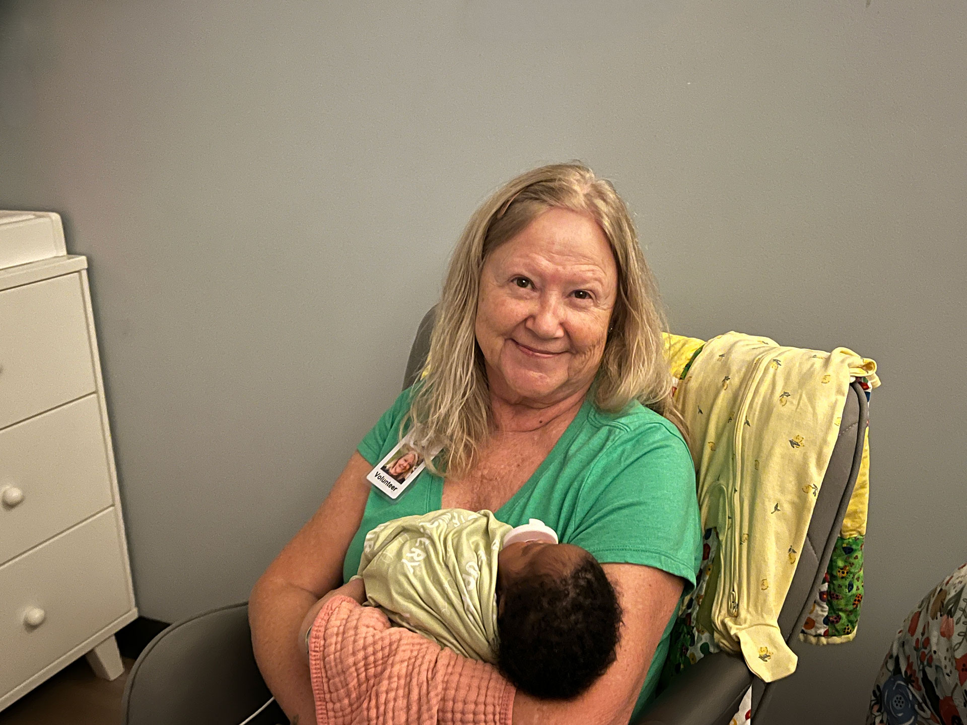 volunteer cuddling baby